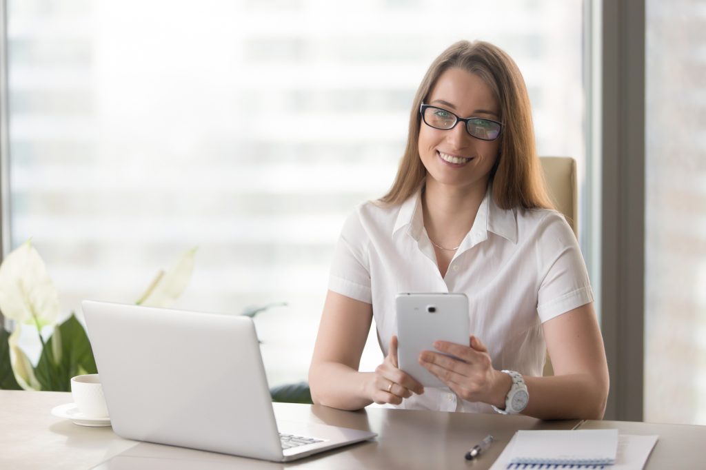 Female entrepreneur using digital tablet in office